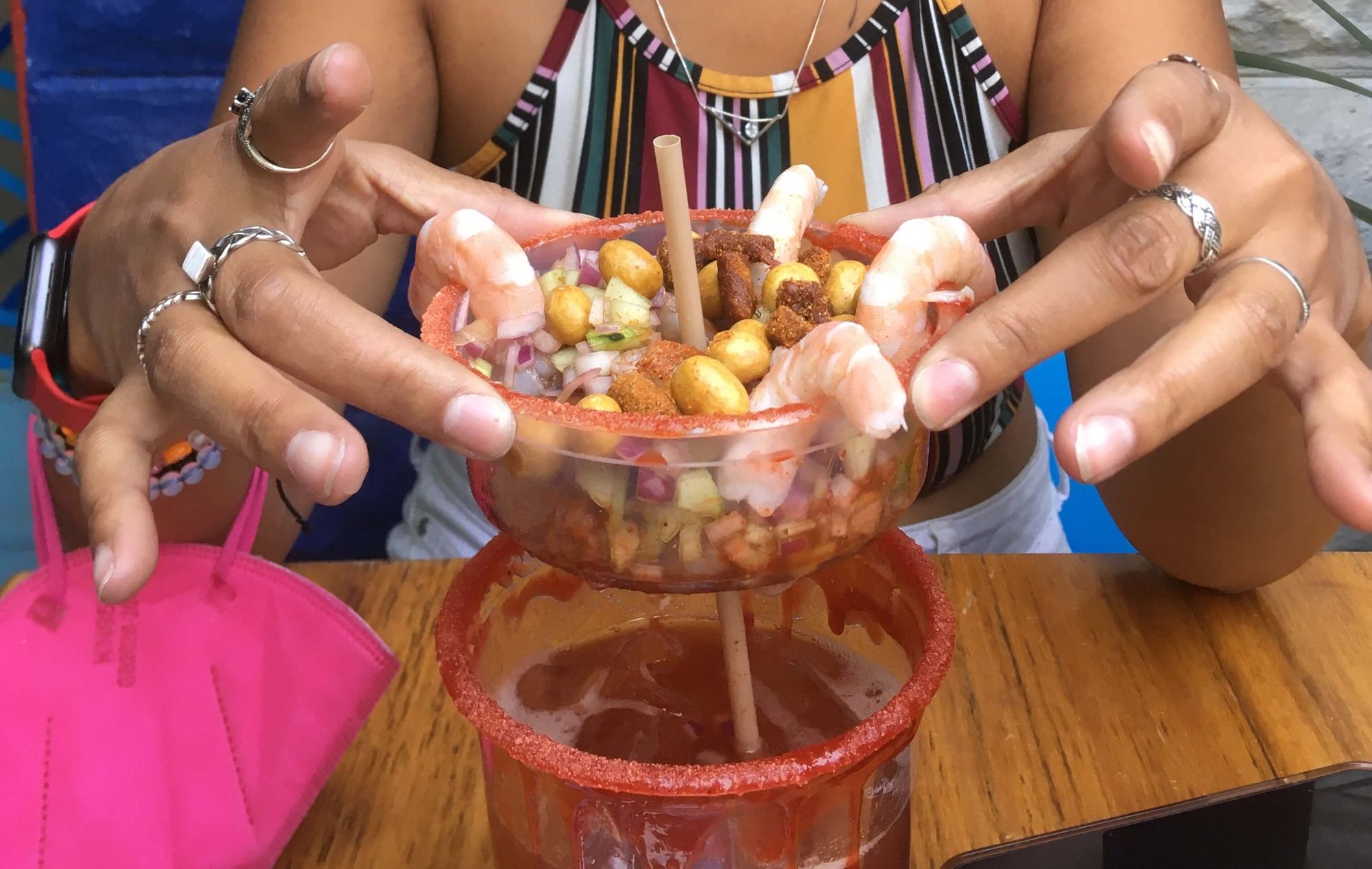 Michelada with shrimps and nuts.