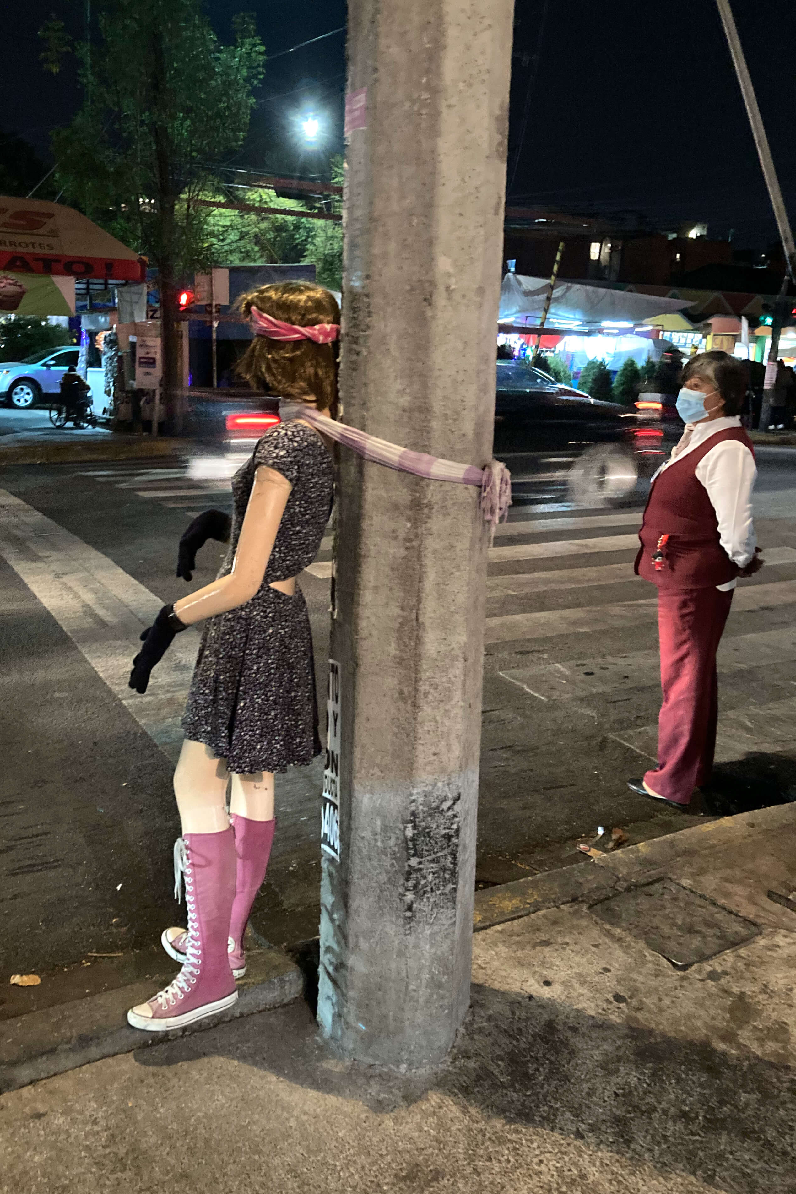 Every day a female mannequin is pulled outside the pub, and the bartender with a menacing scar across his eye caringly dresses her in a new outfit each time.