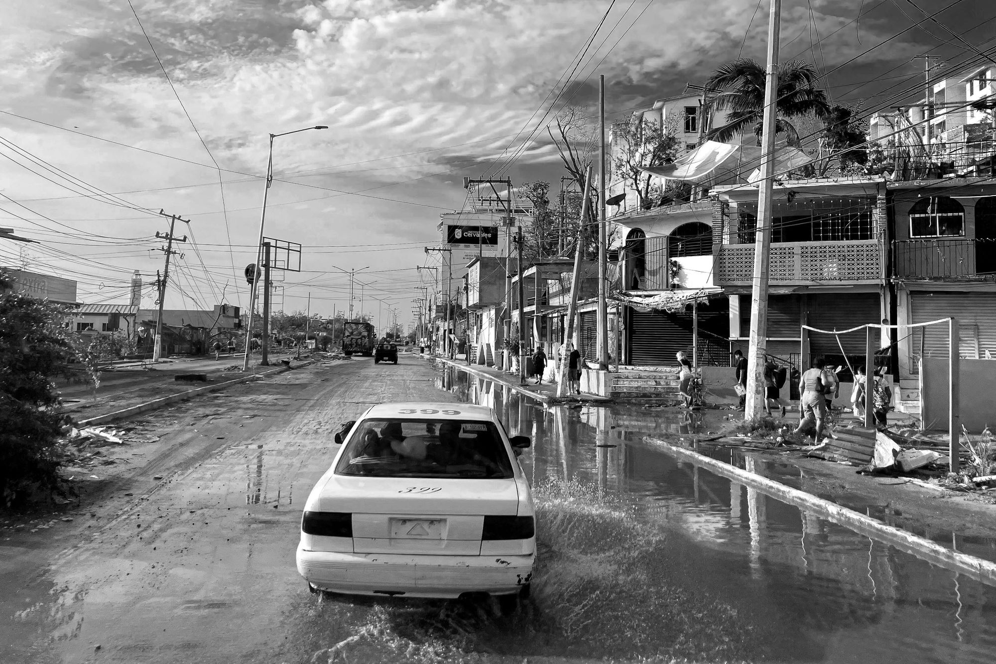 A car is passing through the smashed streets of Acapulco, after it got smashed by the hurricane Otis.